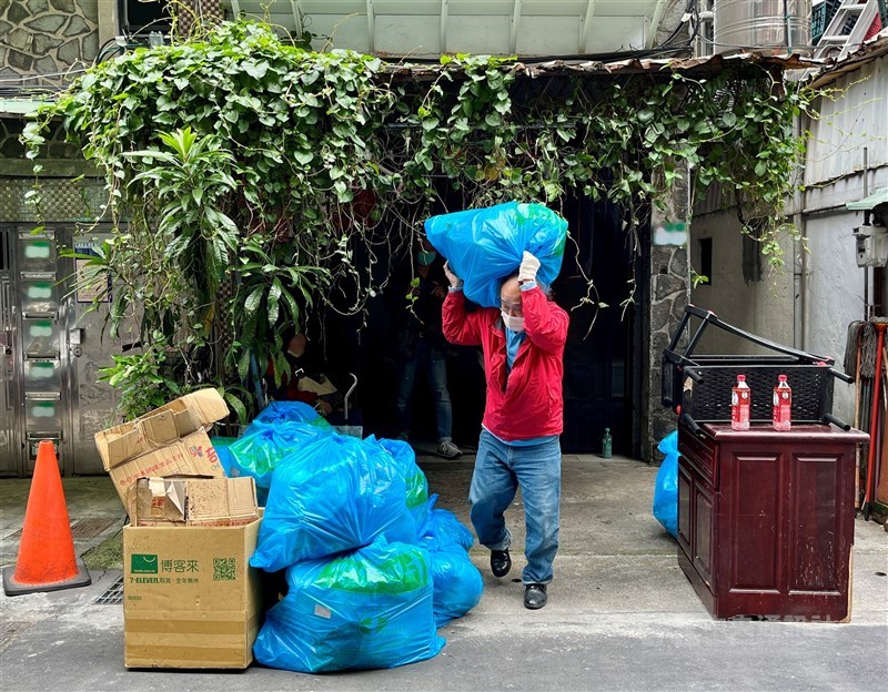 Chen and his colleague pile up 21 bags of trash from the elderly woman’s house they were tasked with clearing out. CNA photo Aug. 31, 2024