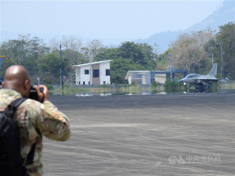 A U.S. military personnel takes photos of an F-16 fighter jet in the Philippines during an exercise held in early May 2024. CNA file photo