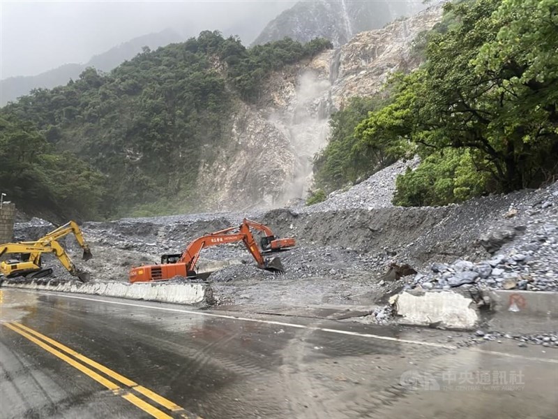 Excavators clear debris caused by mudslides on a section of railway track that runs parallel to Provincial Highway 9 on Sunday. Photo courtesy of the Hualien County Fire Department