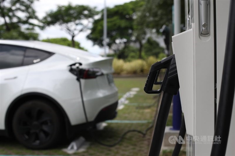 An electric car charges its batteries from a station in this CNA file photo