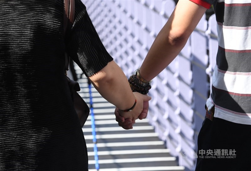 A couple holds hands in this CNA file photo