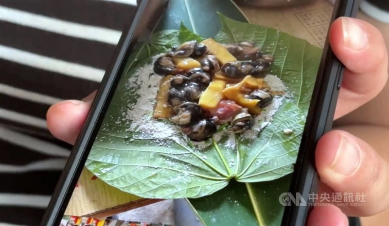 A family member of one of the victims provide a picture of the contents of a millet dumpling to the press. CNA photo Sept. 18, 2024