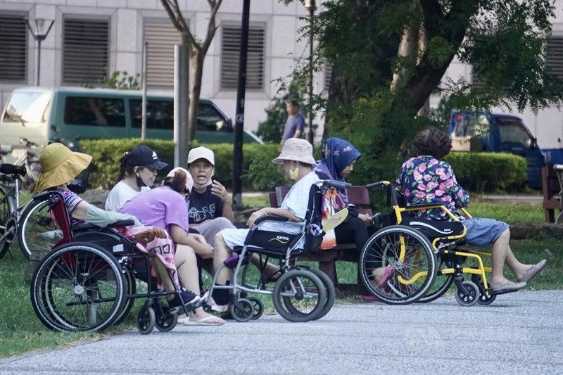 Indonesian caretakers take their charges out for sun in a park in Kaohsiung in this undated photo. CNA file photo