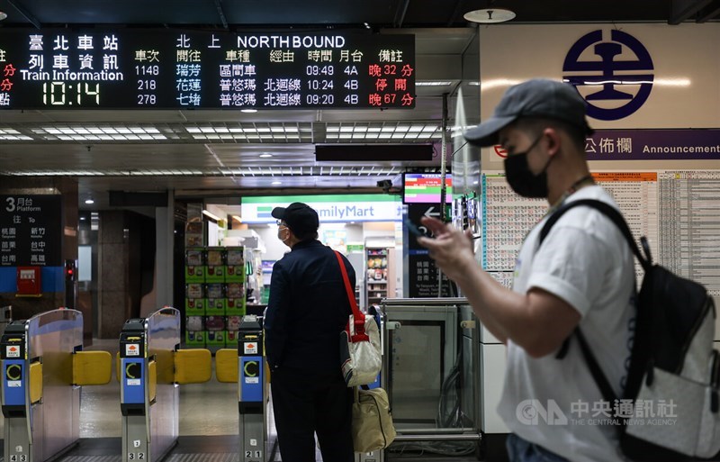 Commuters check out train schedules in this CNA file photo