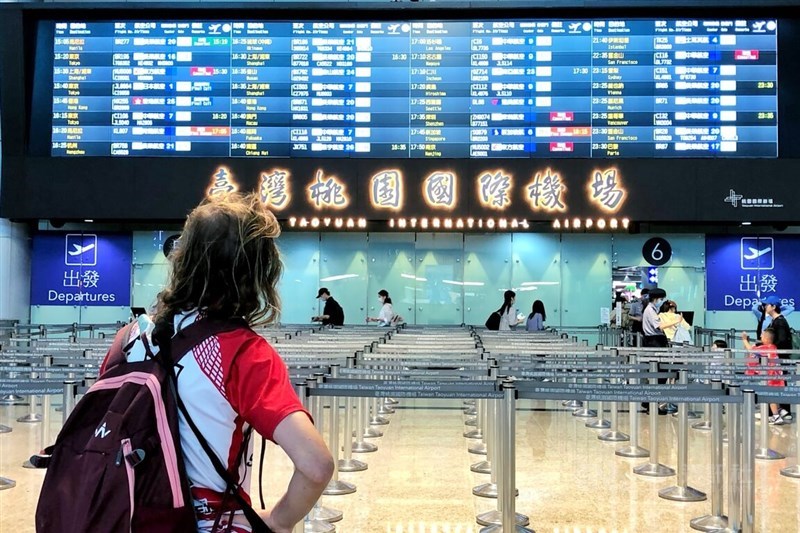 A woman looks at the timetable in the departure hall of Taiwan Taoyuan International's Terminal 2 on Wednesday. CNA photo Oct. 2, 2024