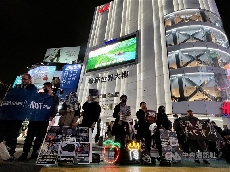 Participants in a campaign held to show solidarity with imprisoned Hong Kongers stand silently near an exit of the Ximen metro station in Taipei on Christmas Eve 2023. CNA file photo