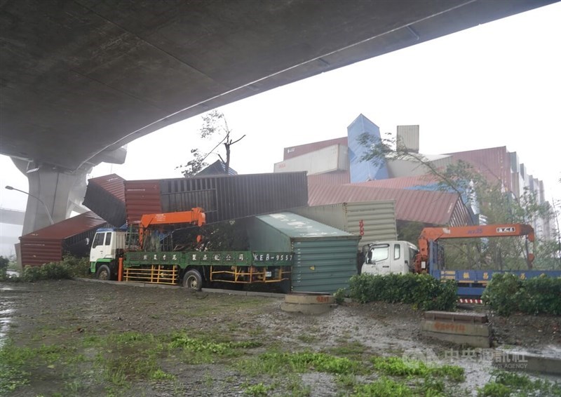 Containers piled up at a container terminal in Kaohsiung topple onto a cargo truck under the winds of Typhoon Krathon on Thursday.