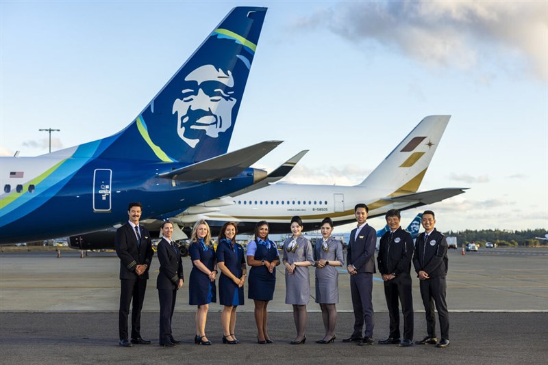 Flight crew from Starlux Airlines and Alaska Airlines stand with their respective carriers in this undated photo courtesy of Starlux Airlines