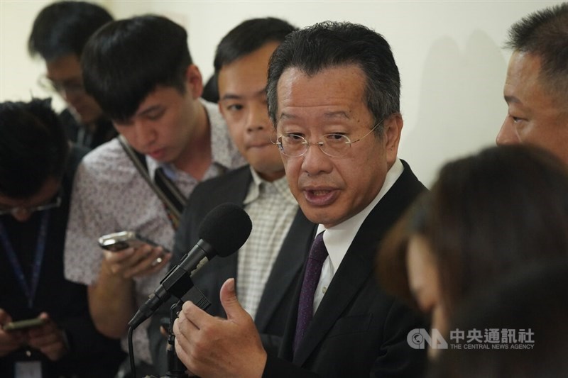 Minister of National Defense Wellington Koo (center) talks to the press at the Legislature in Taipei Monday. CNA Oct. 7, 2024