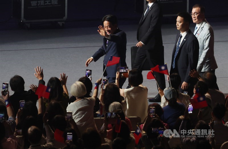 President Lai Ching-te (back, center) waves to the audience when he arrives at the National Day Celebration at Taipei Dome on Oct. 5. CNA photo Oct. 5, 2024