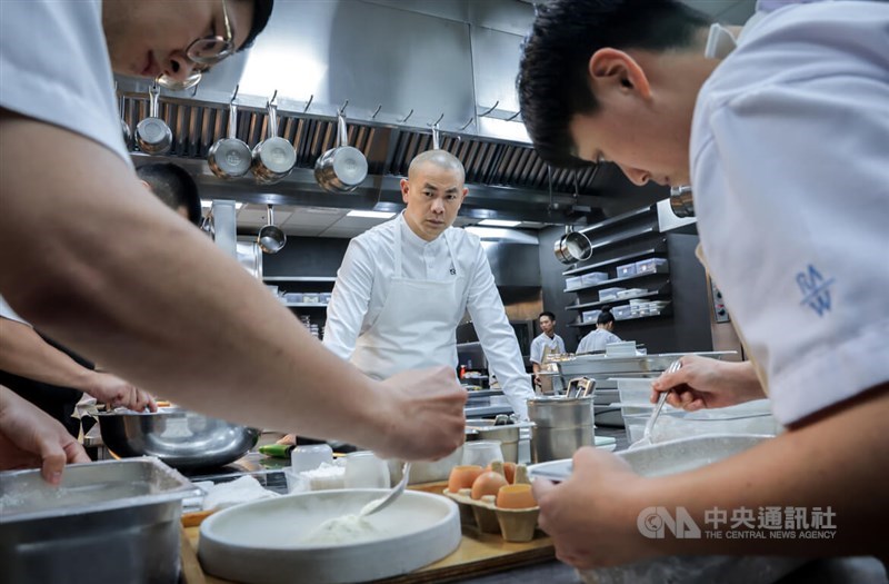 André Chiang (center) supervises his team as they make dishes in the kitchen of RAW, his Michelin two-star restaurant in Taipei, in mid-September. CNA photo Oct. 12, 2024