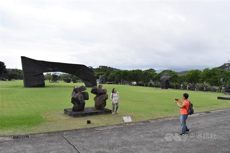 Visitors to the Juming Museum in New Taipei's Jinshan District take pictures with exhibited sculptures after it was reopened Tuesday. CNA photo Oct. 15, 2024