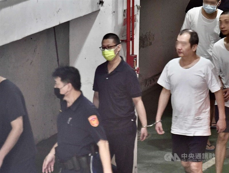 Mao Chun-shen (in yellow mask), a former Taipei preschool worker, received a 28-year prison term in August this year. CNA file photo