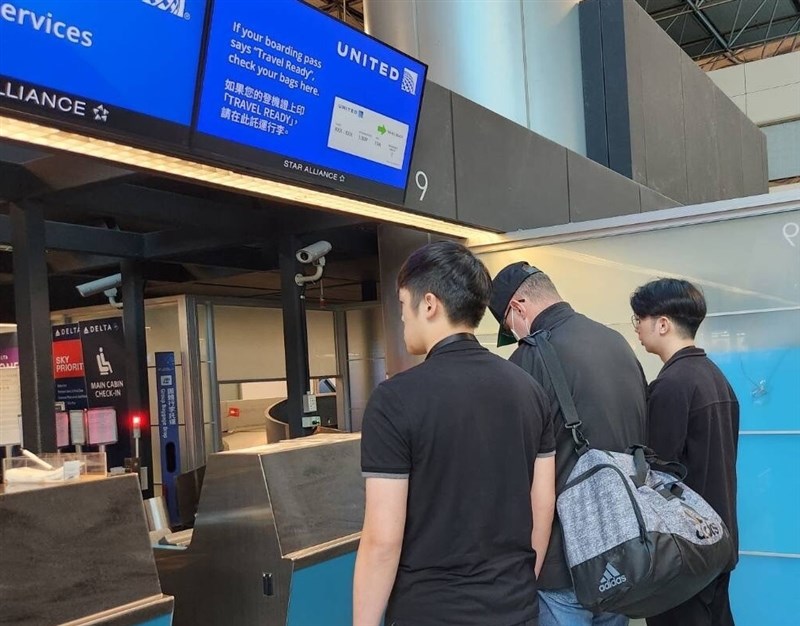 A U.S. national convicted of sexual molestation in the U.S. (center) is escorted by law enforcement officers to an airport on Friday for deportation. Photo courtesy of the NIA