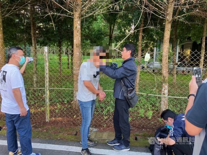 A man (with blurred face) who attacked a woman on a high speed rail train is arrested by law enforcement officers on Sunday. Photo courtesy of the police