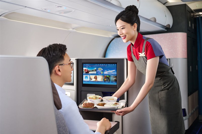 A China Airlines flight attendant serves an airline meal to a business class passenger in this undated photo. Photo courtesy of China Airlines