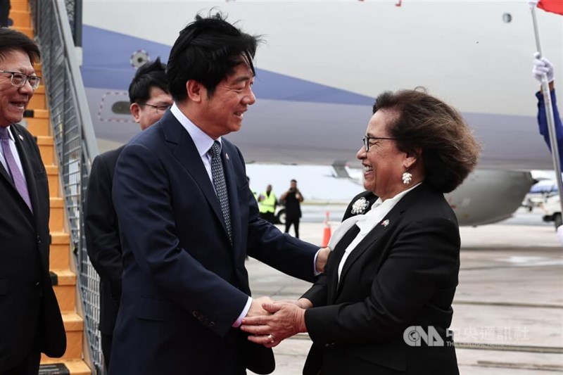 President Lai Ching-te (front left) is greeted by Marshallese President Hilda Heine (right) on his arrival at Majuro, the capital of the Marshall Islands, on Tuesday. CNA photo Dec. 3, 2024