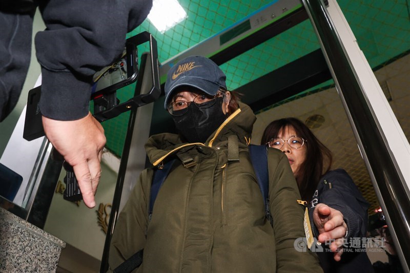 Former Ministry of Labor official Hsieh Yi-jung (in mask) at the New Taipei District Prosecutors Office on Wednesday. CNA photo Dec. 11, 2024