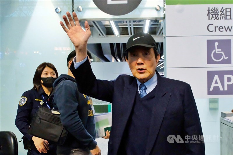 Former President Ma Ying-jeou (right) waves to the press as he departs for China at the Taoyuan International Airport Wednesday. CNA photo Dec. 18, 2024