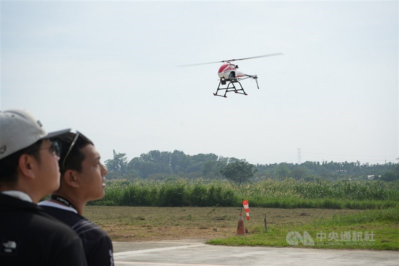 Two people look at a drone flown at a recreational park for RC planes. CNA file photo for illustrative purpose only