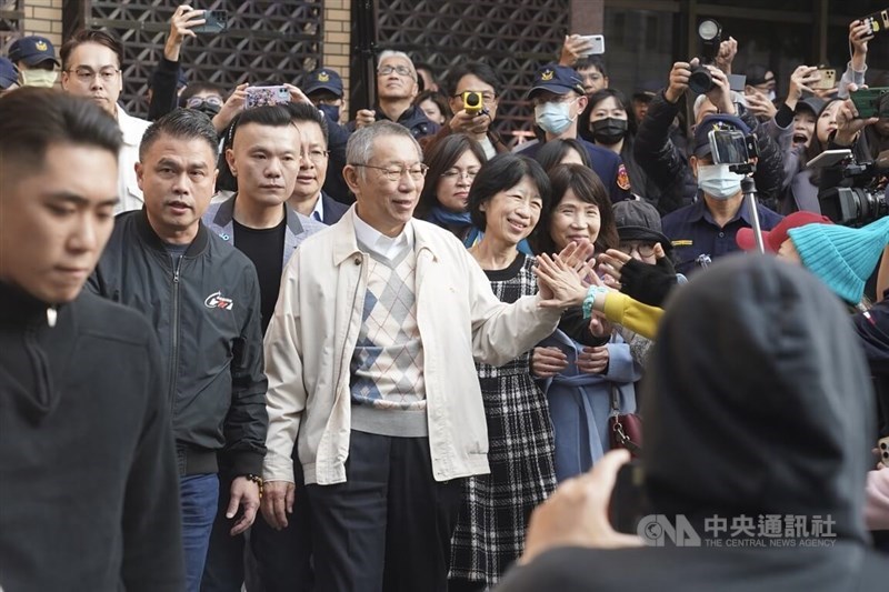 Taiwan People's Party Chairman Ko Wen-je (center, in white jacket) and his wife, Chen Pei-chi (in plaid dress), high-five supporters as they leave the Taipei District Court after posting bail on Monday. CNA photo Dec. 30, 2024