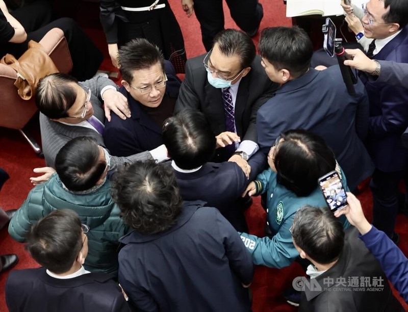 Lawmakers try to break up two of their peers who traded heated words inside the Legislature on Monday. CNA photo Jan. 20, 2025