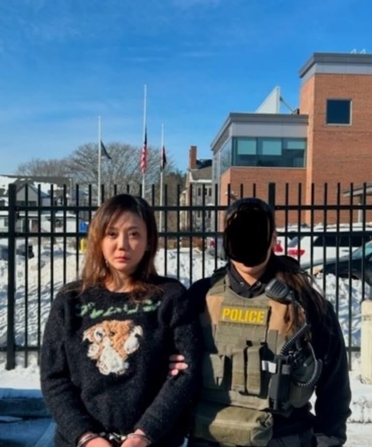 An ERO agent from ICE takes Taiwanese fugitive Johanne Liou into custody in Boston. Photo courtesy of local authorities