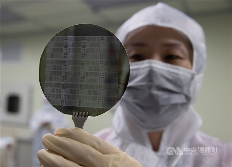 A technician inspects a silicon wafer at a semiconductor plant in Taiwan. CNA file photo