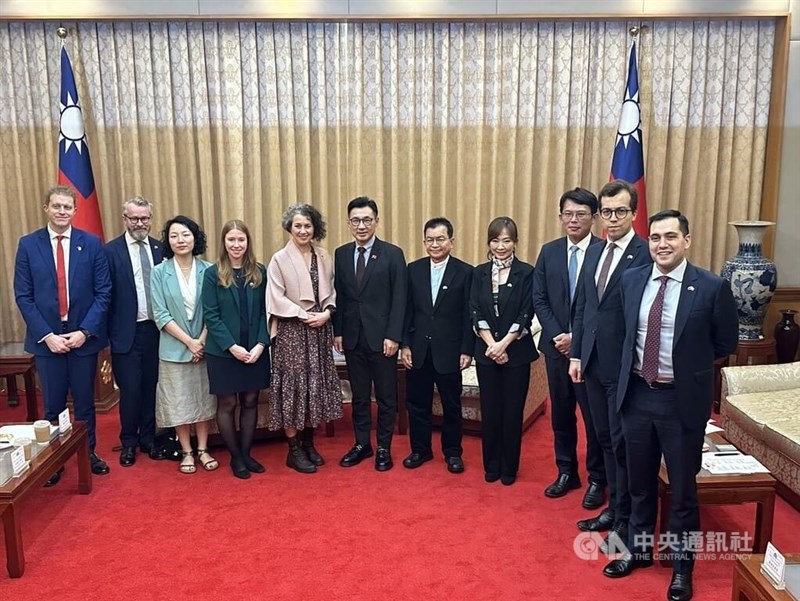 Deputy Legislative Speaker Johnny Chiang (center) and local lawmakers pose with a visiting U.K. parliamentary delegation for a group photo on Monday. CNA photo Feb. 17, 2025