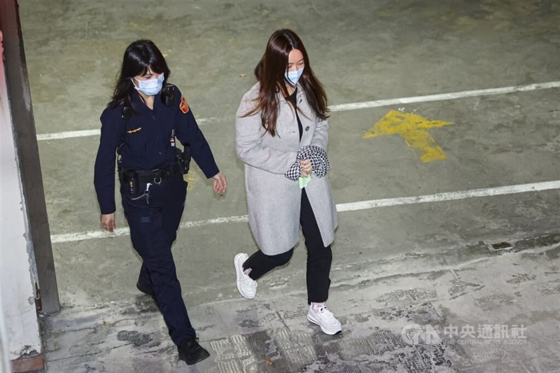 Taipei City Councilor Chen E-jun (right) is escorted by a police officer Thursday to be detained over alleged corruption. CNA photo Feb. 20, 2025