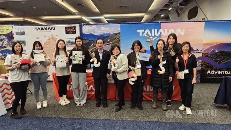 Staff members at the Taiwan booth in the Vancouver Outdoor Adventure & Travel Show pose for photos. CNA photo March 2, 2025