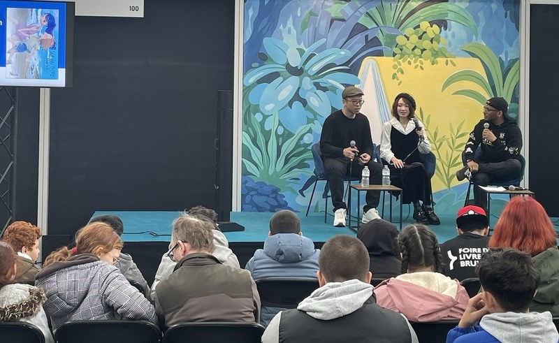 The Taiwanese manga artist known as "Monday Recover" (星期一回收日, center on stage) appears at Foire du Livre, a French-language book fair which is being held in Brussels, Belgium. CNA photo March 16, 2025