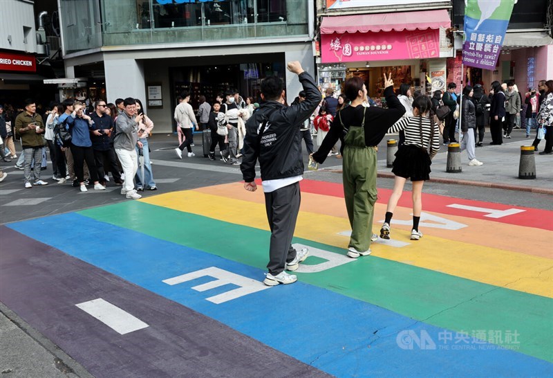 Pedestrians pose for photos on the vibrant rainbow crosswalk near Ximen Metro Station in Taipei. CNA file photo