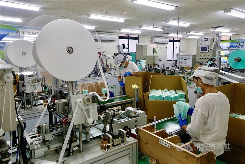 Workers man an assembly line in this CNA file photo
