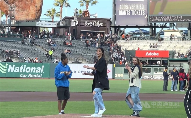 Kaitlyn Chen (center) who is newly drafted into the WNBA's Golden State Valkyries, throws out a ceremonial pitch on Thursday. CNA photo May 1, 2025