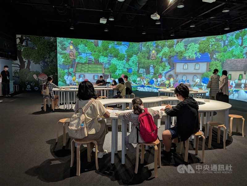 Visitors to exhibition "Crossing Realms: a Gender and Light Journey in the Metaverse" participate in a drawing exercise in this photo taken in April. CNA photo May 3, 2025