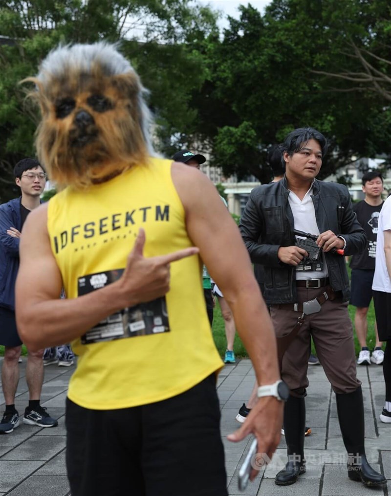 A runner dons a Wookiee mask and participates in the 2025 Star Wars Run inside the New Taipei Metropolitan Park on Sunday, while a cosplayer poses as Han Solo behind him. CNA photo May 4, 2025