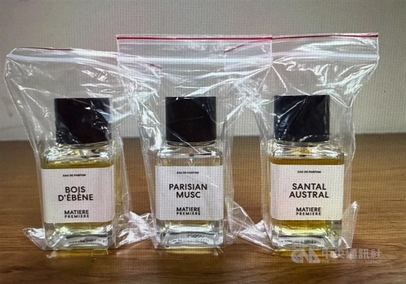 Three bottles of fancy cologne stolen by a 38-year-old unemployed man from Taipei department stores are displayed as evidence by the police. Photo courtesy of local authorities