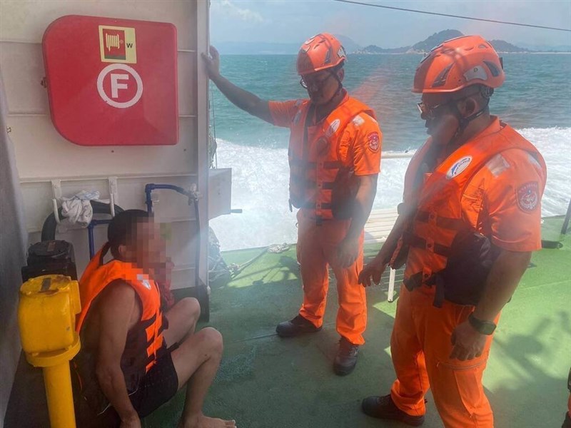 Two Coast Guards question a Chinese national on Friday morning after he attempted to swim to Kinmen's Dadan Island using a flotation ring. Photo courtesy of the Coast Guard's Kinmen-Matsu-Penghu Branch