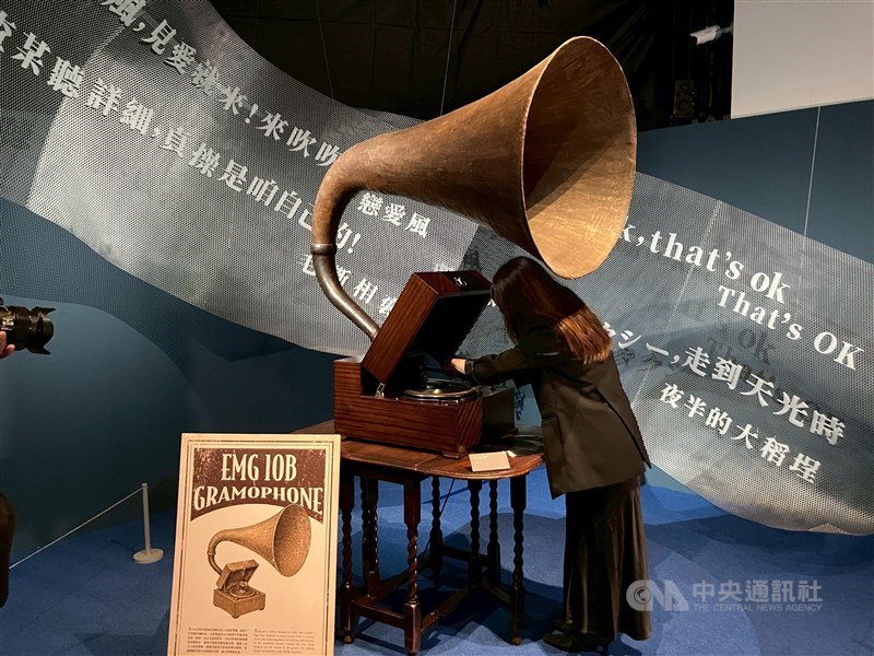 A woman cues up a track on a gramophone at Modern Era: The Dawn of Pop Music” exhibition in Taipei. CNA photo May 23, 2025