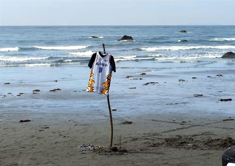 Family of the missing student hoists his jersey on a beach, hoping for a miracle. Photo courtesy of a private contributor