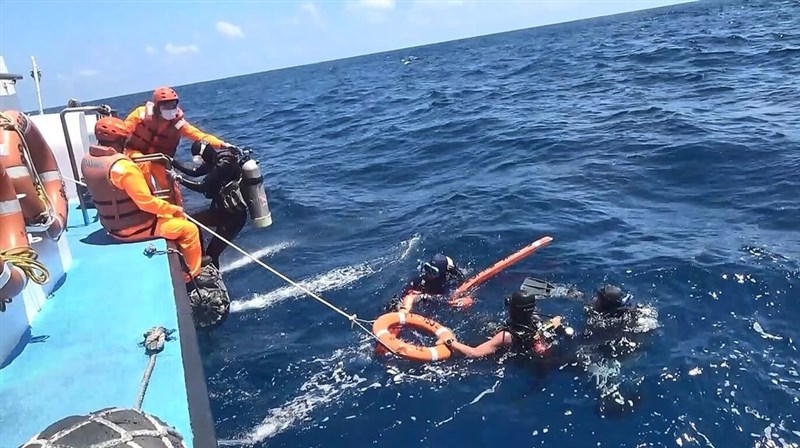 An undated photo shows coast guard officers in the water with a lifebuoy. Photo courtesy of the Coast Guard Administration