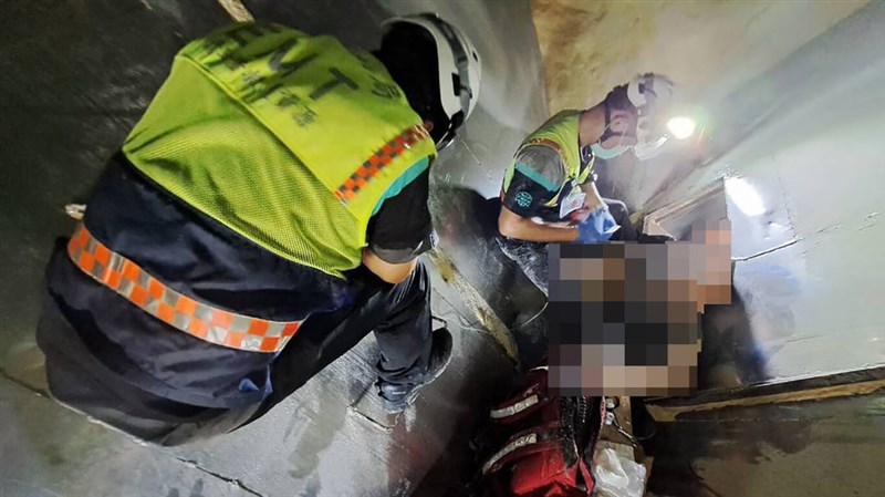 Rescuers attempt to pull out a man whose leg was caught in a corn crusher on Tuesday morning. Photo courtesy of a private contributor