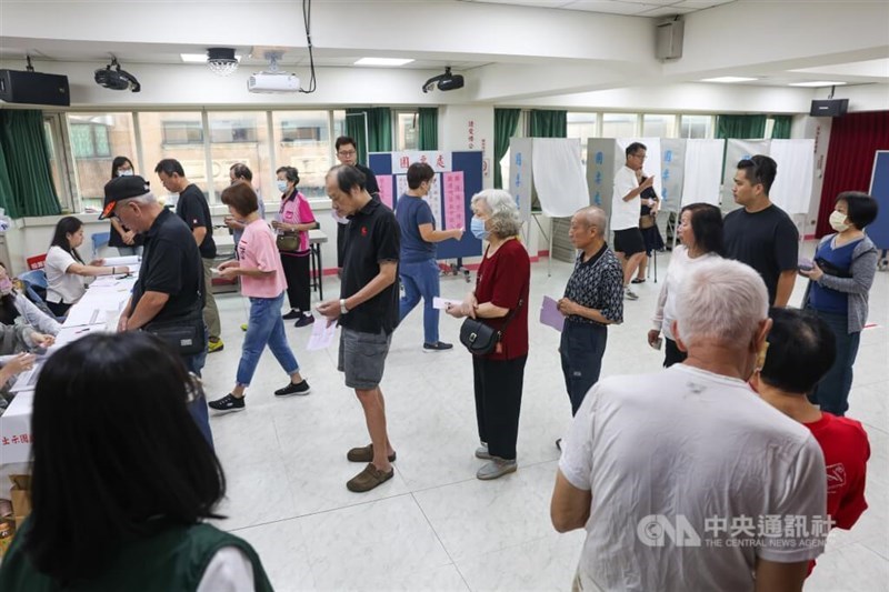 An undated photo shows voters lining up inside a polling station to collect their ballots in preparation to vote. CNA file photo