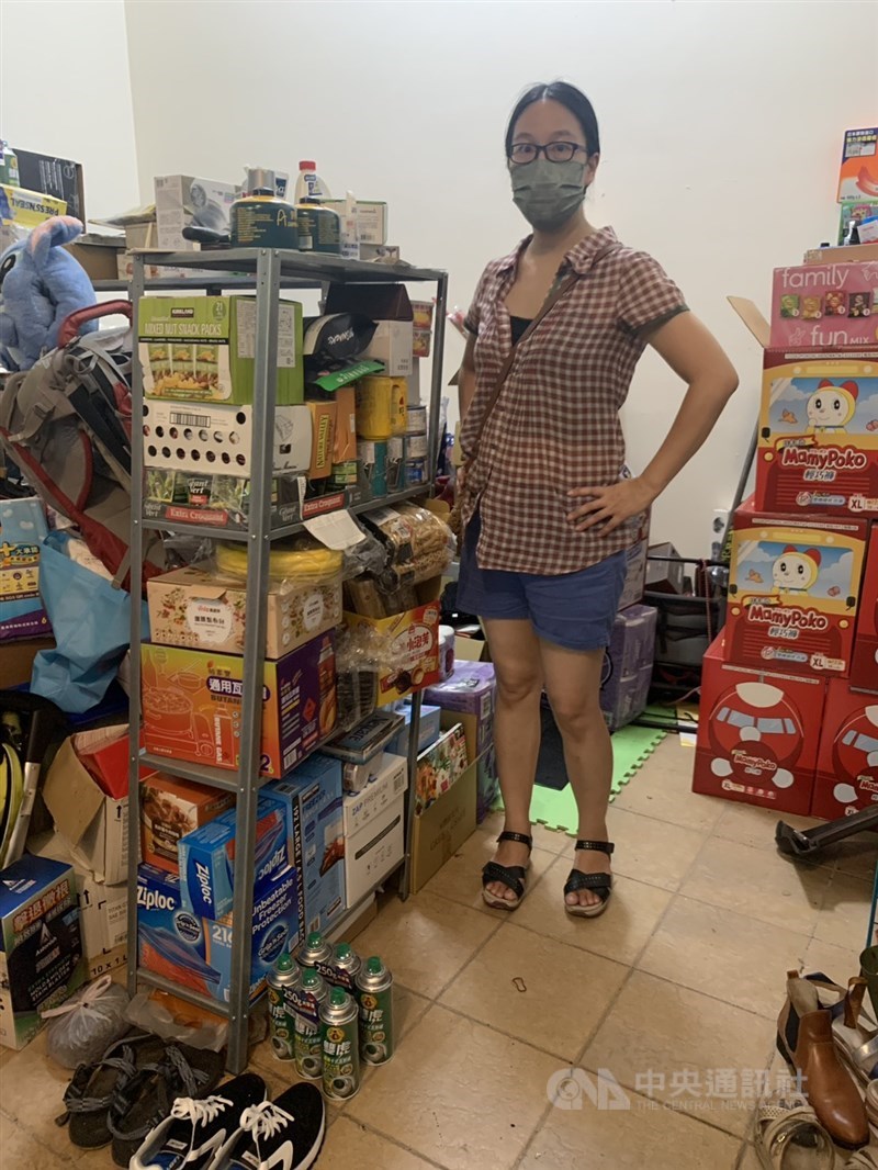 Schoolteacher Amy Chang stands next to a stockpile of emergency supplies she has prepared at her home in Taoyuan, with the goal of sheltering in place for two to three months in case of a war. Photo courtesy of Amy Chang, July 4, 2025