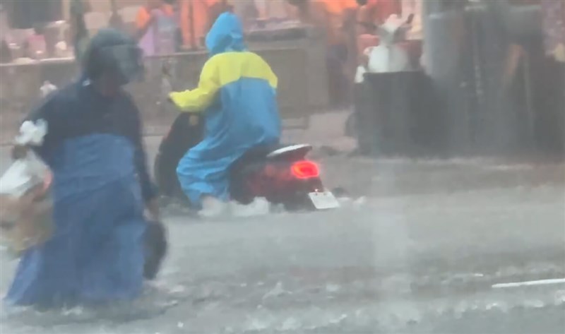 One man tries to control his scooter in the pouring rain in front of the Changhua Tianhou Temple on Tuesday. July 8, 2025