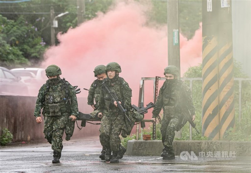Reservists carry a simulated casualty during a drill in which they defend a logistics supply site from enemy attack in northern Taiwan on Friday. CNA photo July 11, 2025