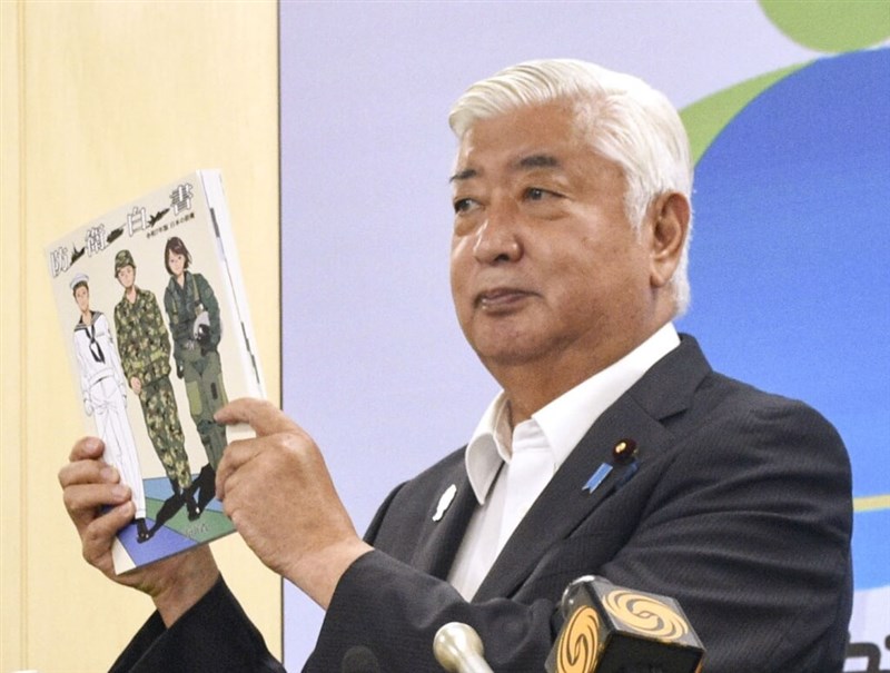 Japanese Defense Minister Gen Nakatani displays a copy of the 2025 edition of Japan’s Defense White Paper in Tokyo on Tuesday. Photo courtesy of Kyodo News July 15, 2025