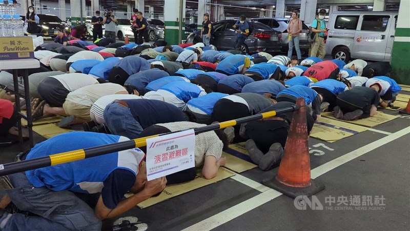 Participants take cover using standard evacuation postures during Tuesday's drills in Taichung. CNA photo July 15, 2025