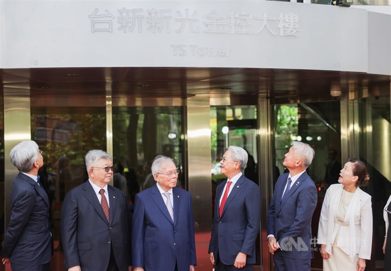 TS Financial Chairman Thomas Wu (third right) and former Minister of Economic Affairs Wang Mei-hua (right) stand in front of the TS Tower in Taipei on Thursday. CNA photo July 24, 2025